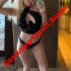 Mirror selfie of a woman in black lingerie posing in a hotel room, with a bold diagonal red text overlay reading 'Gaziantep Escort Bayan' across the image.