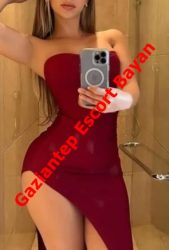Woman in a red off-shoulder dress taking a mirror selfie in a bathroom; diagonal watermark reads 'Gaziantep Escort Bayan'.