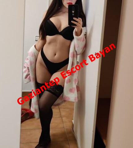 Mirror selfie of a woman in black lingerie and thigh-high stockings with a pink robe, posing in a doorway; red text overlay reads 'Gaziantep Escort Bayan' indicating an escort advertisement.
